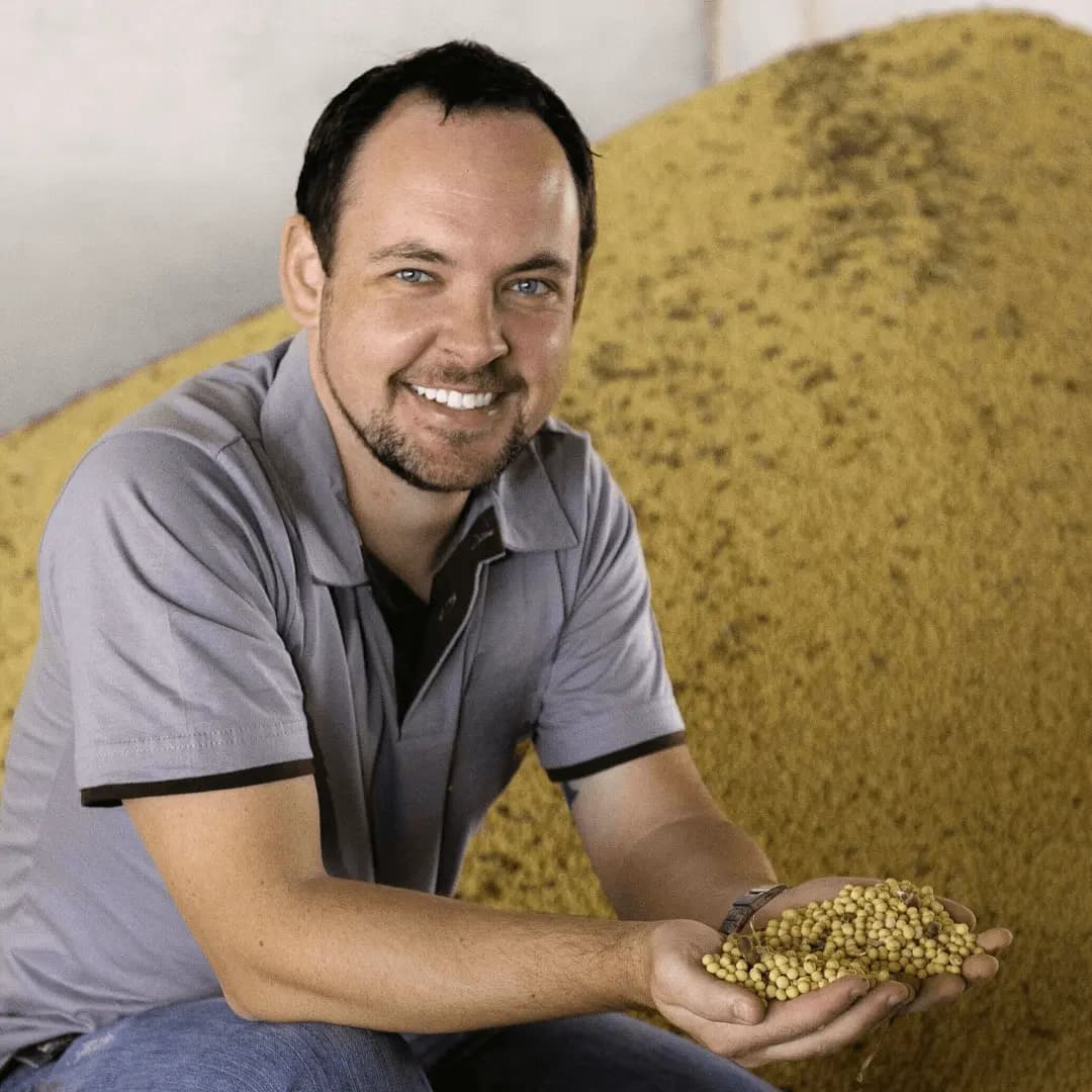 Gustavo Bonato segurando grãos de soja